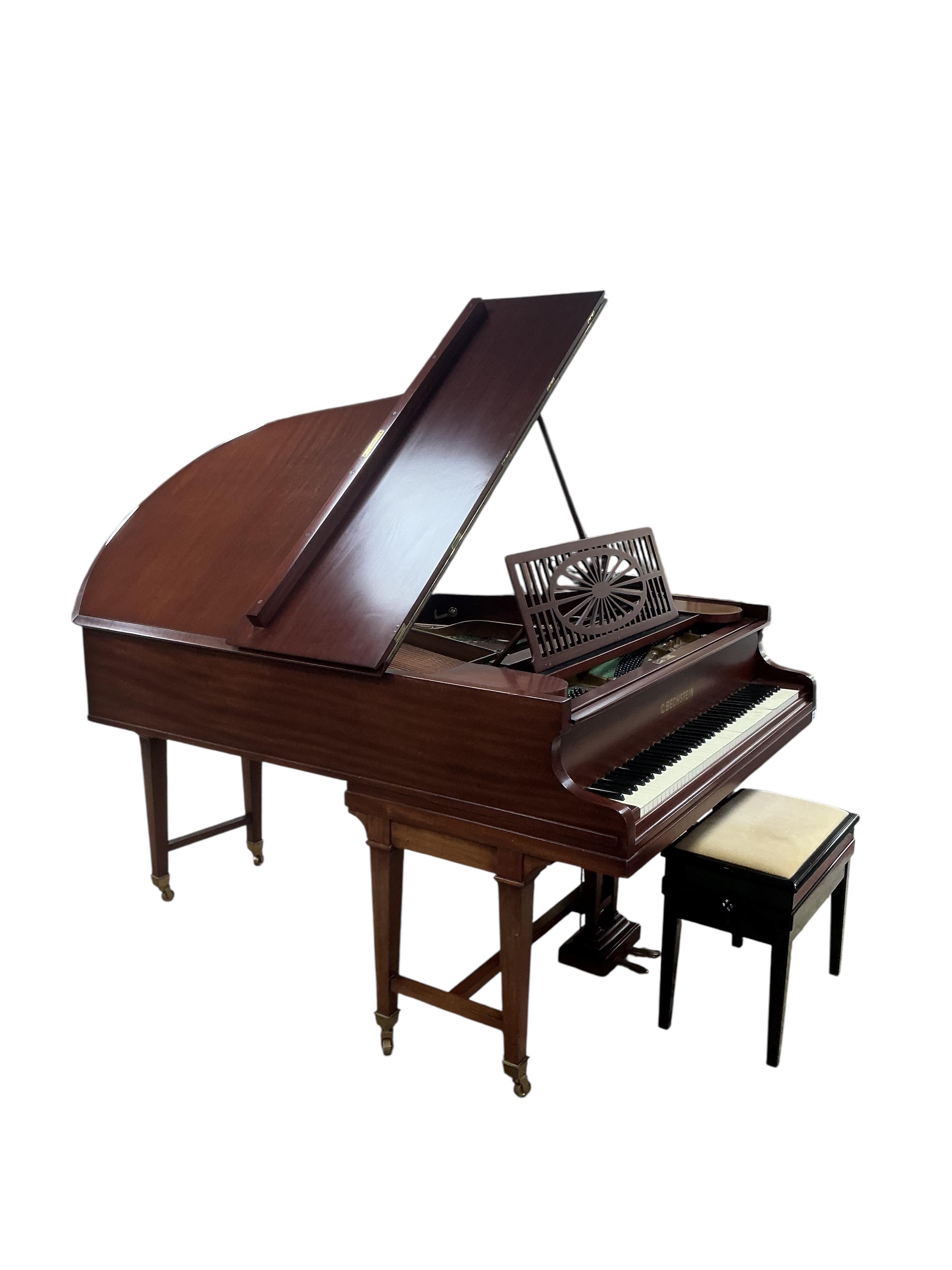 A Bechstein mahogany cased boudoir grand piano, model A, number 96003 (c.1910). Recently restrung, new felt to hammers and case re-polished, together with an adjustable ebonised piano stool. Length 182cm, depth 144cm.